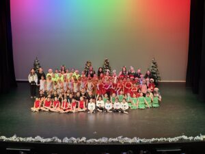 a rainbow background with a group photo of dancers